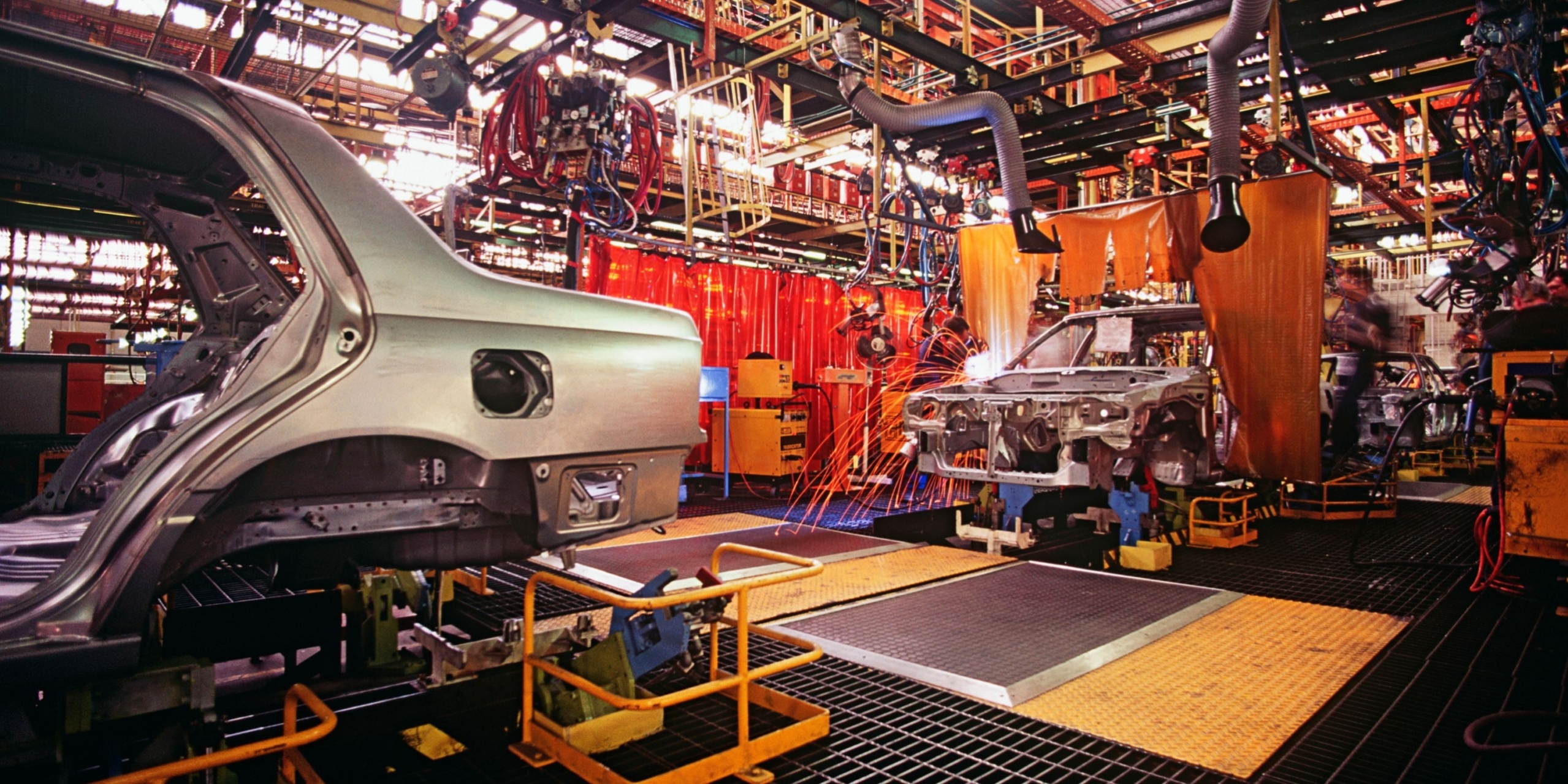 Car being manufactured on an assembly line.