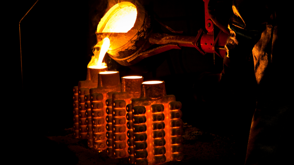 pouring molten iron into a cast